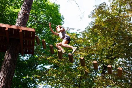 man goes up rope ladder